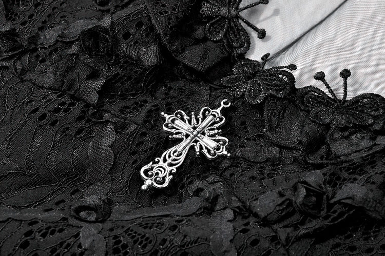 Close-up of decorative silver cross on Dark Romantic Lace Mini Dress with Corset Waist and Cross, showcasing delicate lace detail.