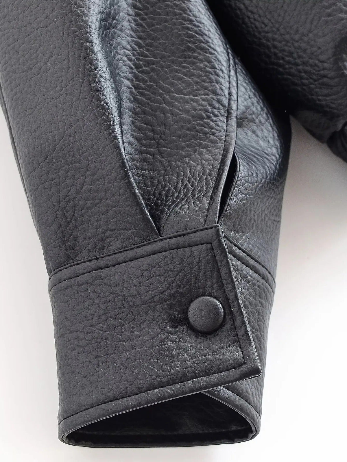 Black asymmetrical leather-look jacket detail view
